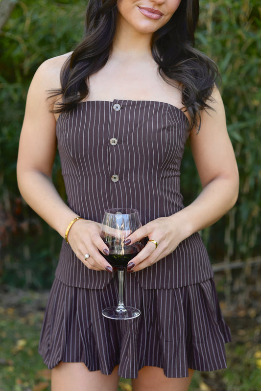 Fashionable brown striped strapless dress with buttons and flared skirt, perfect for casual outings.