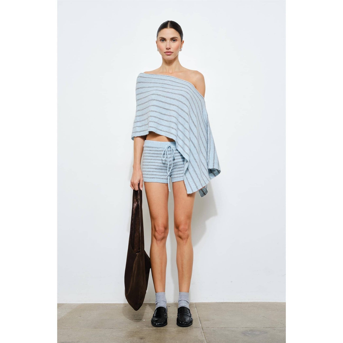 Woman wearing a striped outfit with a white background