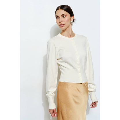 Ivory long-sleeve cardigan with button front, made from soft knit fabric, styled with a satin skirt.