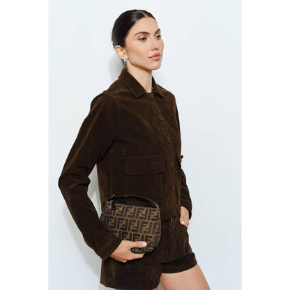 Brown suede jacket with pockets, featuring stylish model holding a Fendi patterned bag.