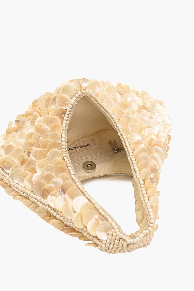 Beige headband with shell-like embellishments on a white background