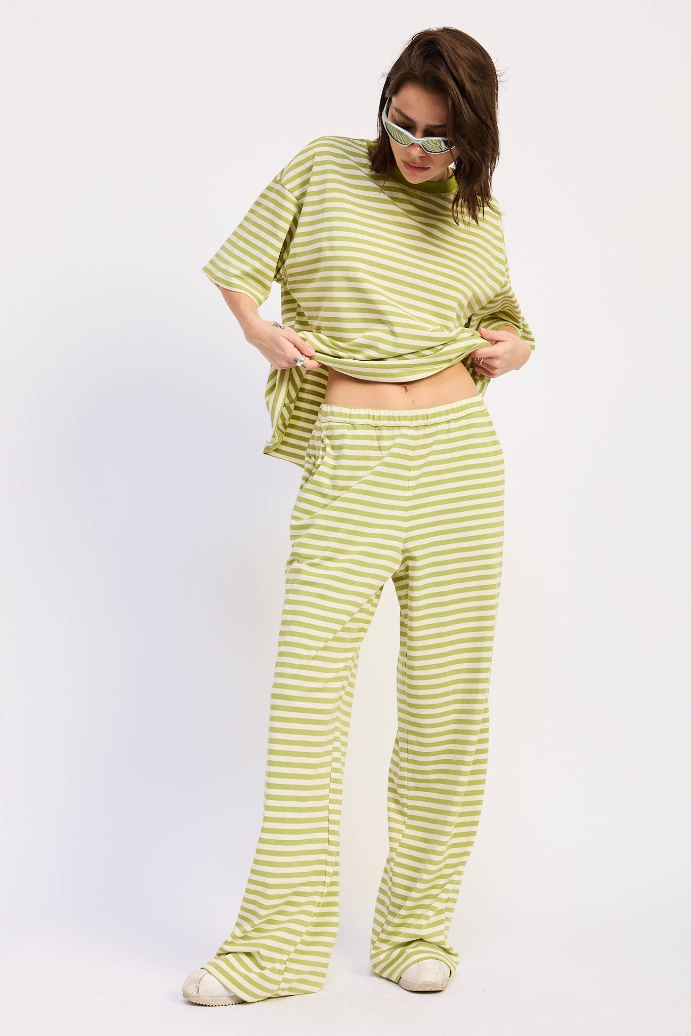 Person wearing a green and white striped outfit on a white background