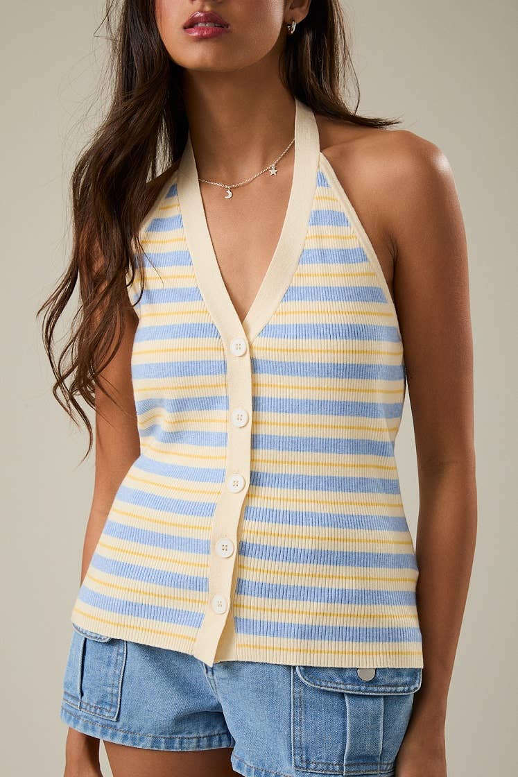 Woman wearing a striped halter top and denim shorts against a neutral background