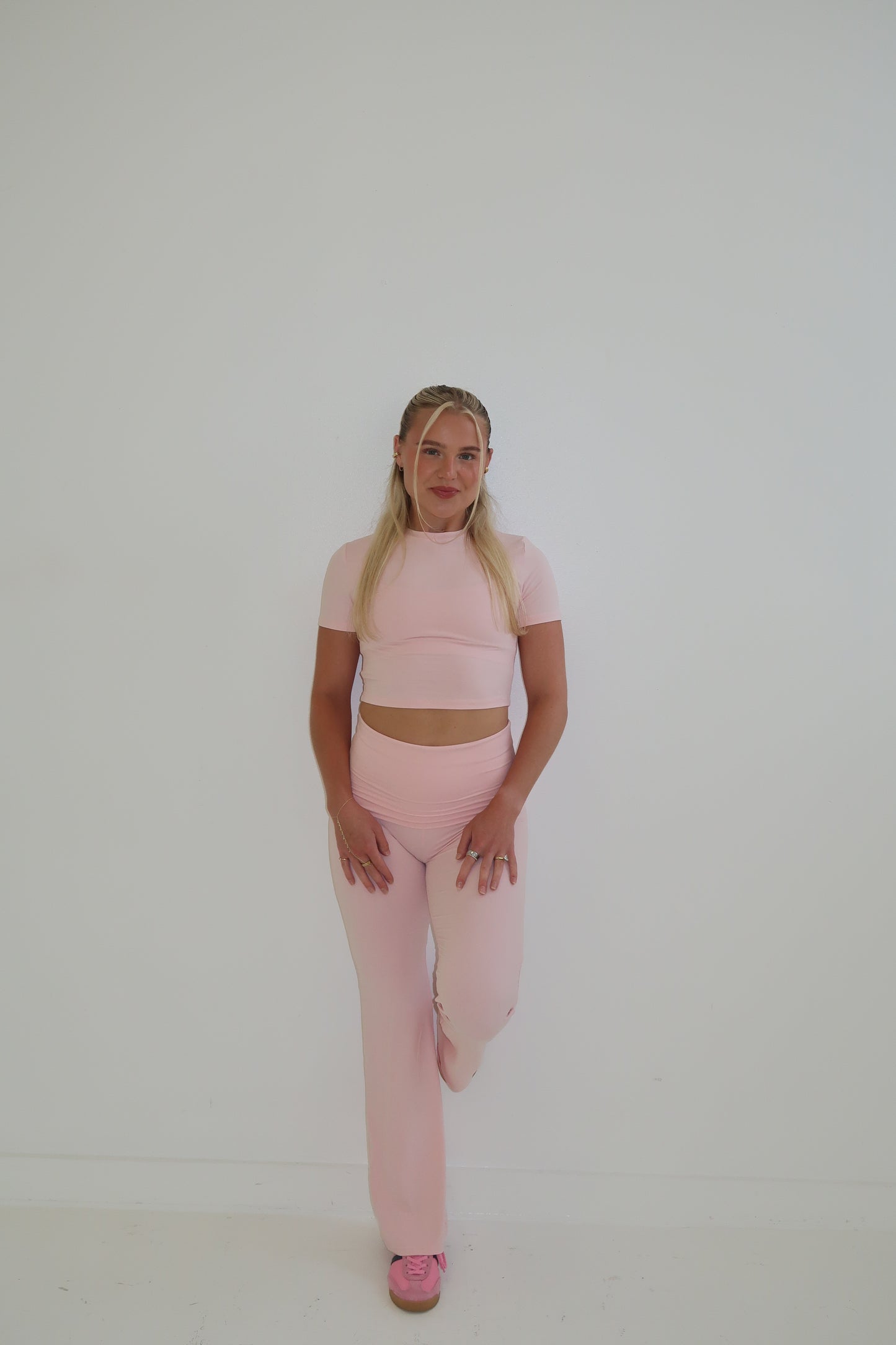 Person wearing a pink outfit  on white background