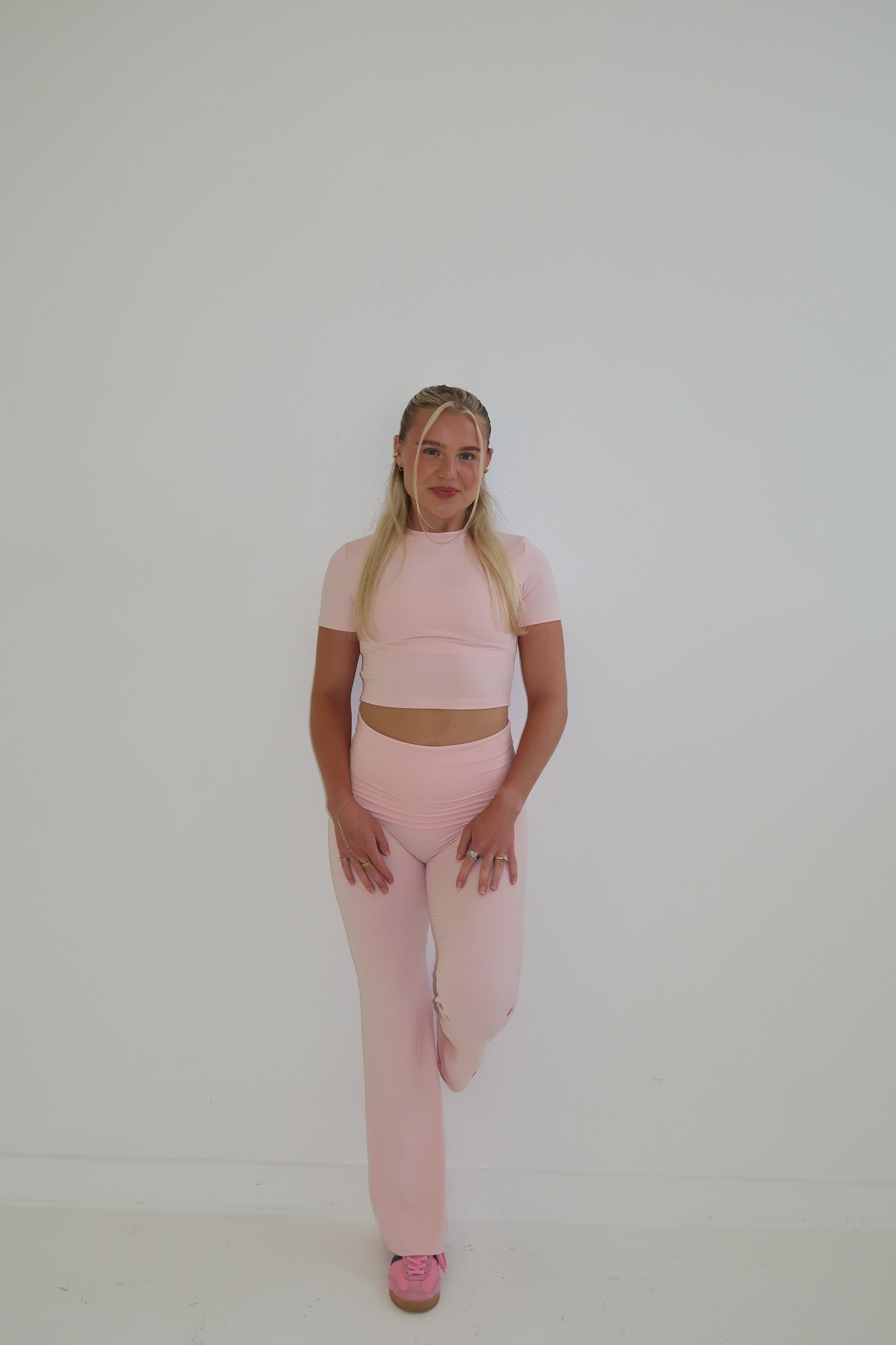 Person wearing a pink outfit  on white background
