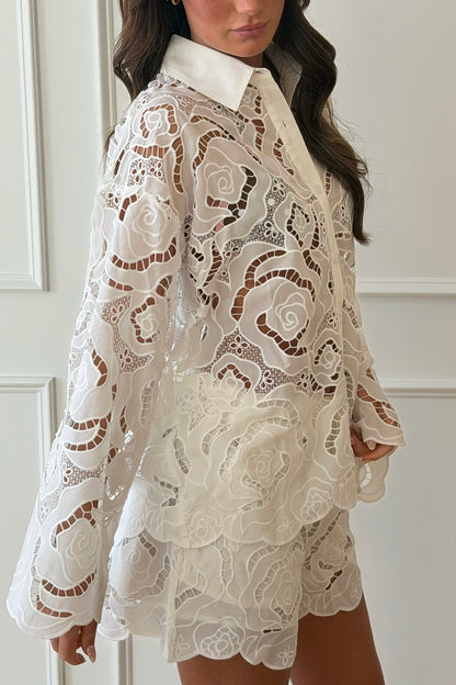 Woman wearing a white lace set with a plain background