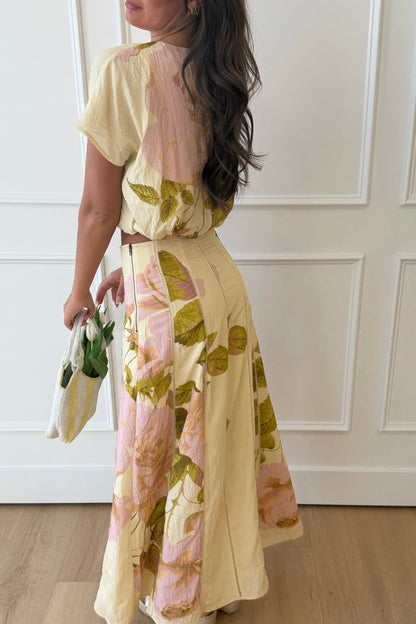 Woman wearing a floral dress with a neutral background