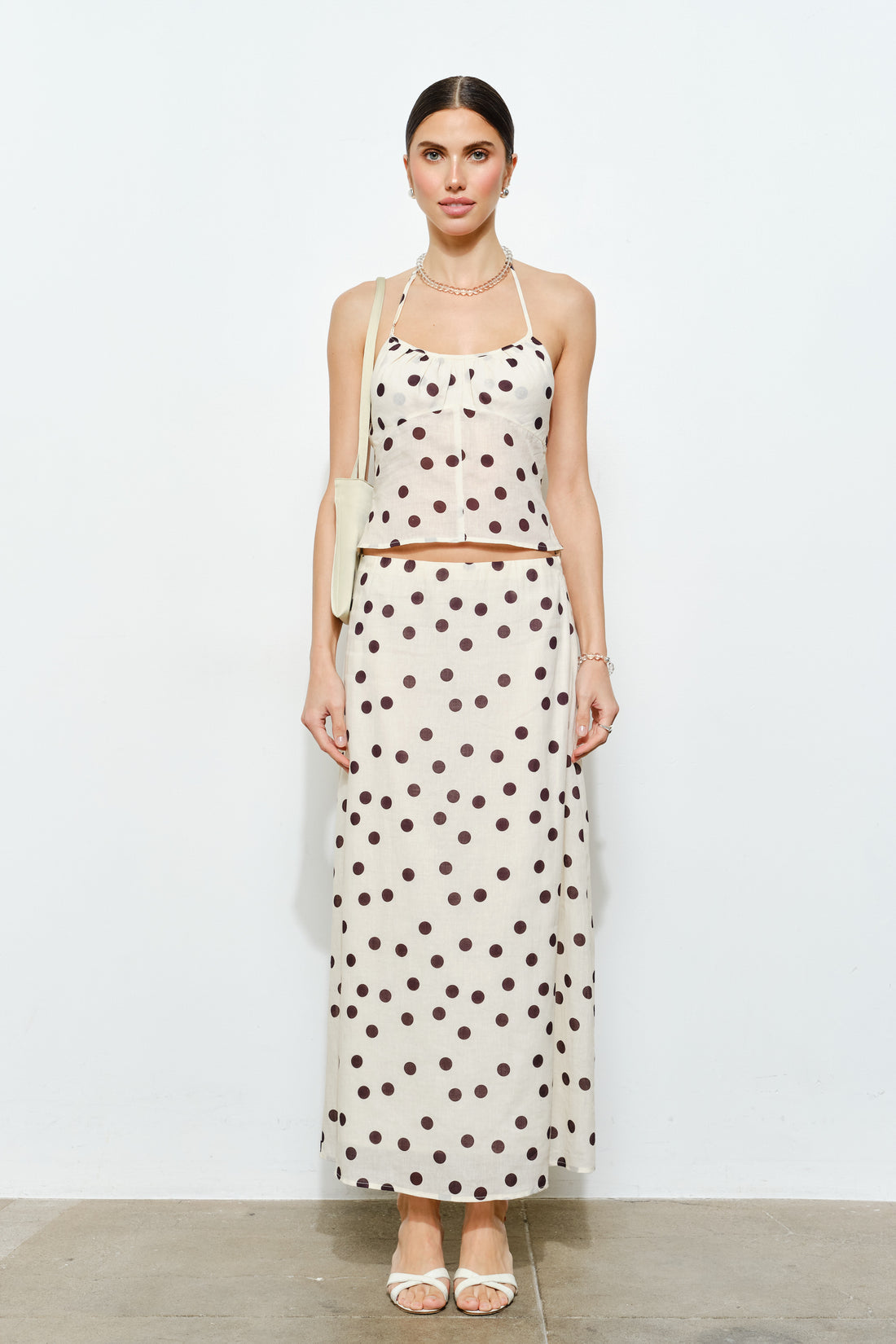 Woman wearing a polka dot dress on a white background