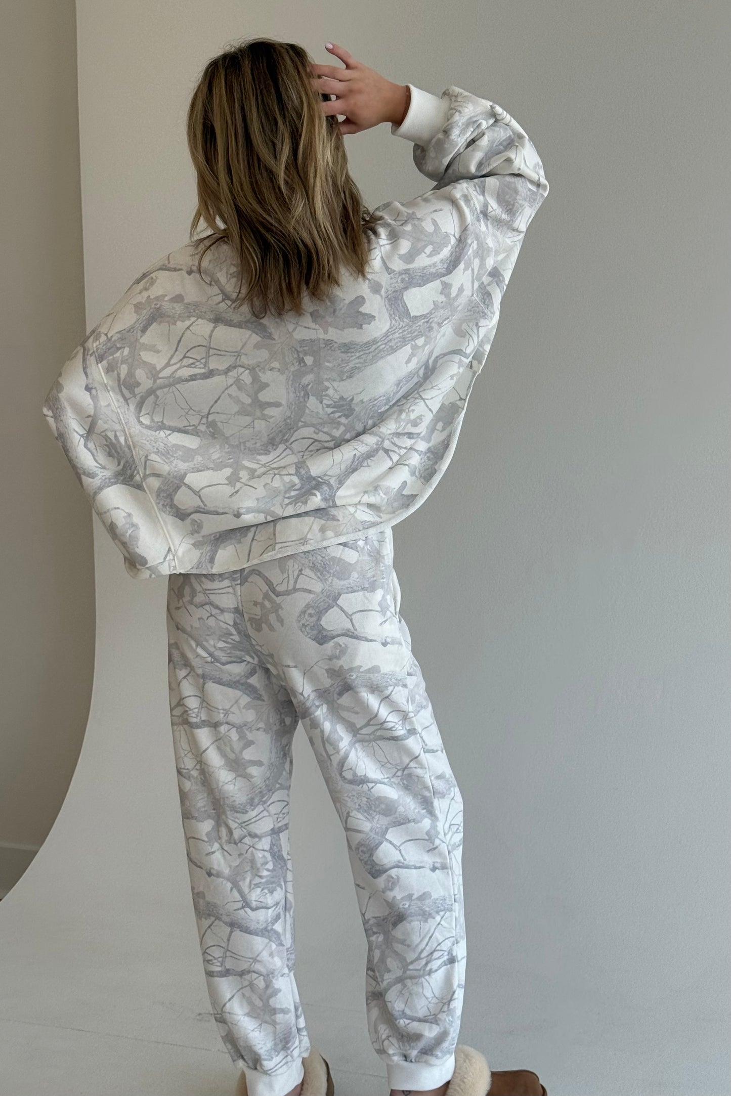 Person wearing a matching marble-patterned outfit against a plain background