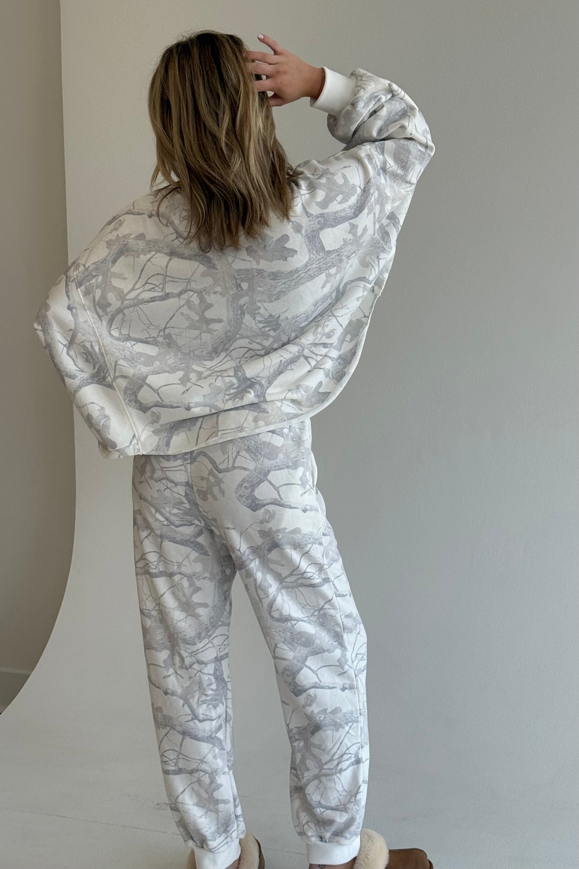 Person wearing a matching marble-patterned outfit against a plain background