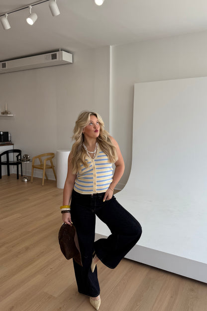 Woman posing in a room with wooden floor and white walls