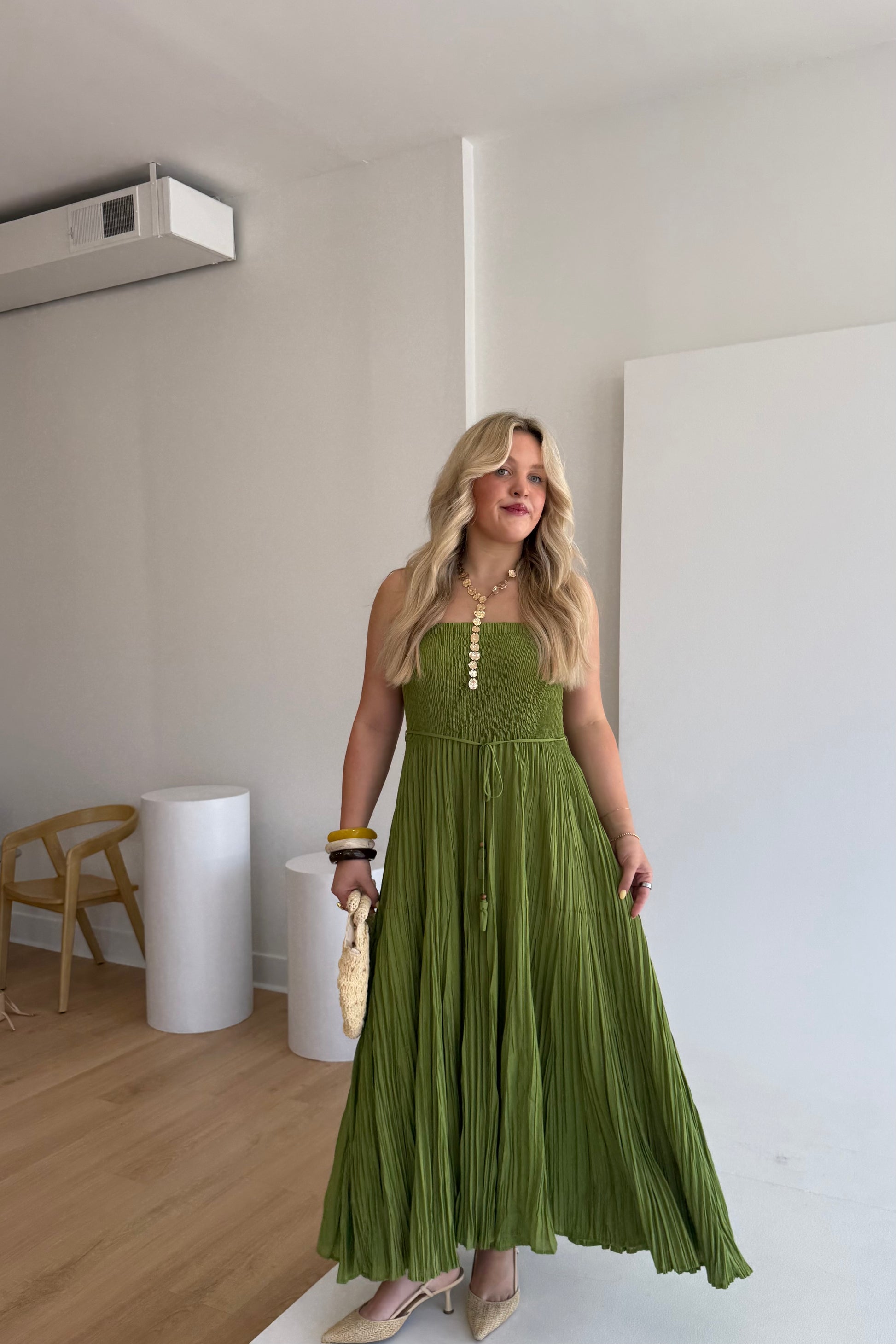 Woman wearing a green dress in an indoor setting