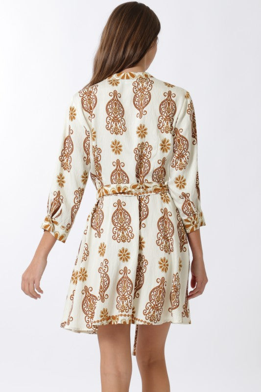 Woman wearing a patterned dress on a white background