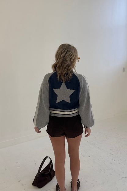 Stylish cropped jacket with gray and navy star design, perfect for casual outfits.