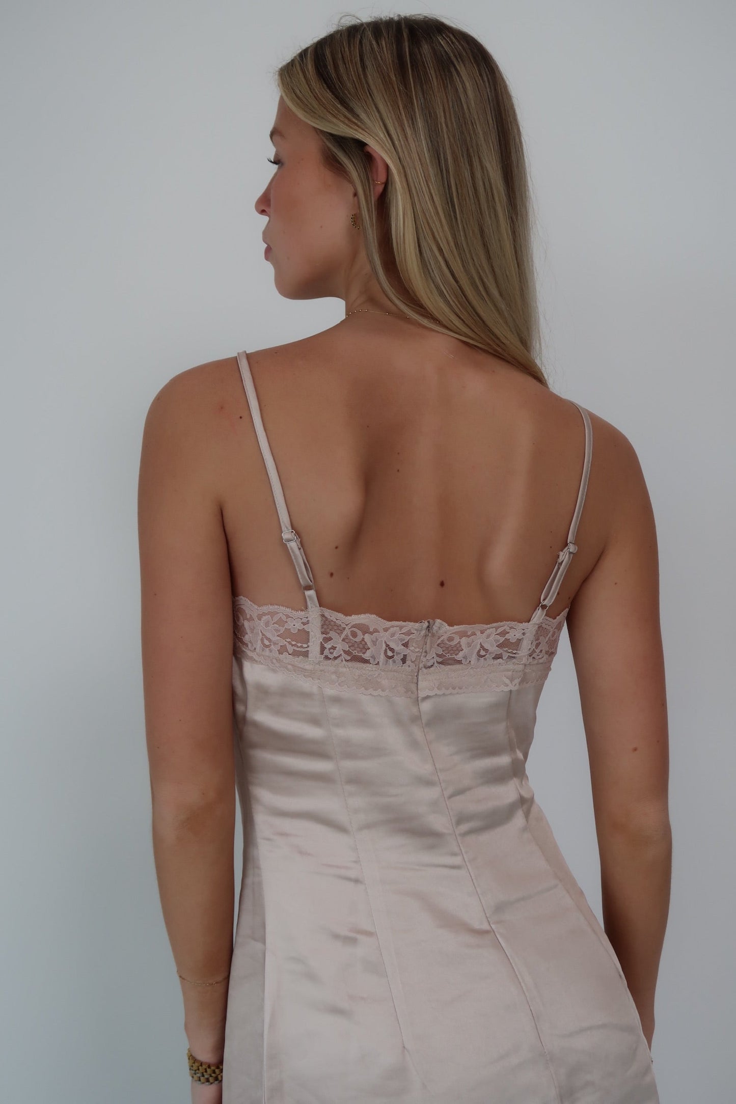 Light pink satin slip dress with lace trim adjustable straps and back zipper.