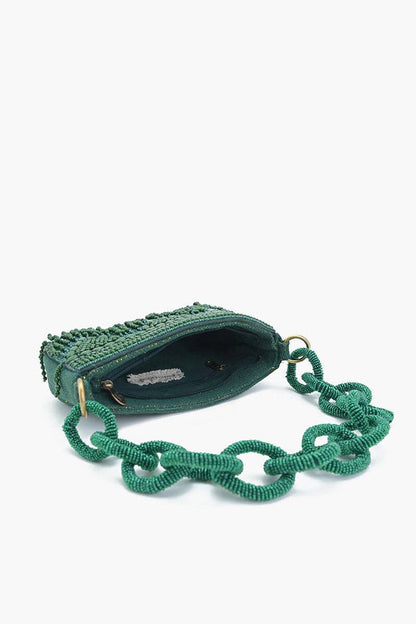 Green handbag with chain strap on a white background